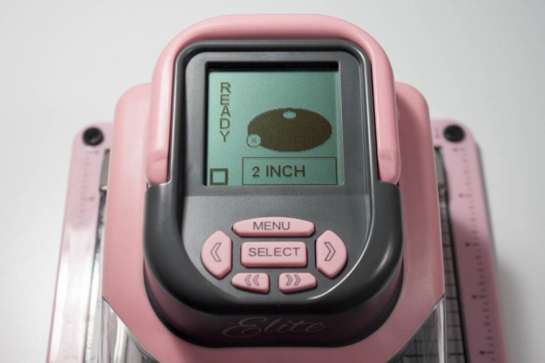 To ensure that the 2-inch-tall oval window was centered on my patterned cardstock when cutting with my Making Memories Slice Elite, I first made a cut onto a 4-inch-square piece of cardstock. I used an oval tag on the "Remember This" design card. 